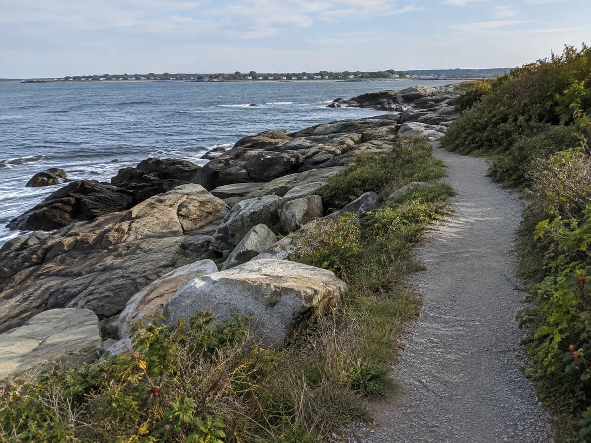 Rocky shore and public path scene inspired by Newport