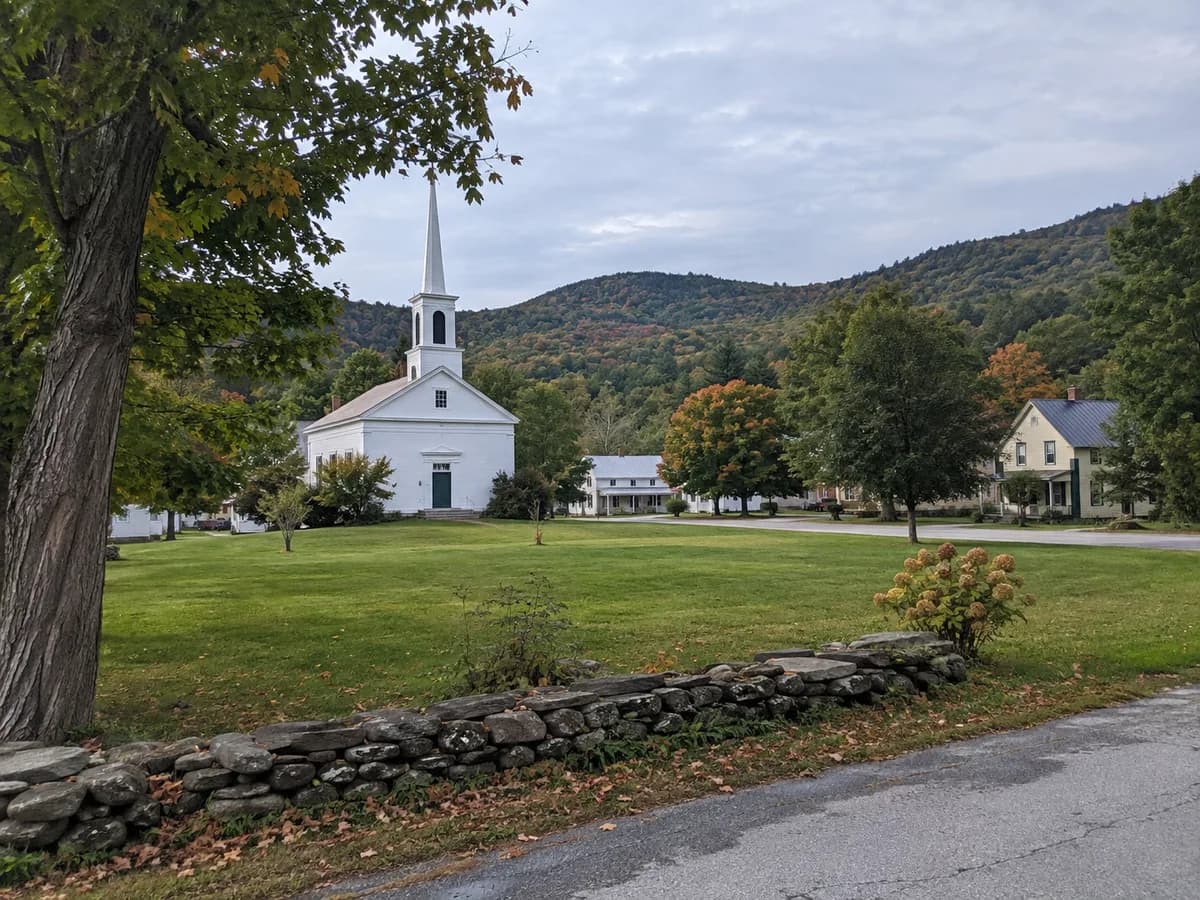 Village green and wooded hill scene inspired by rural Vermont